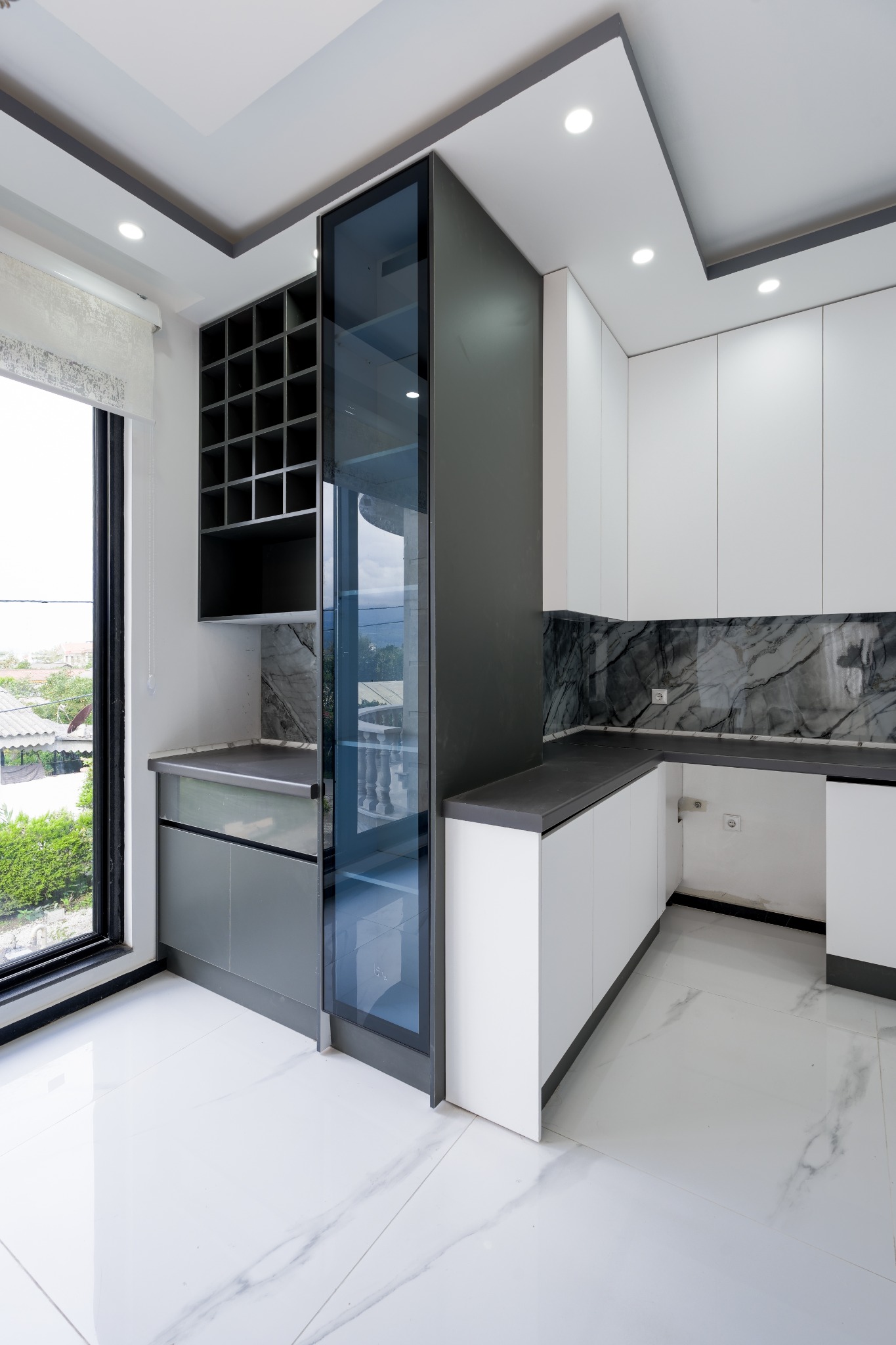 Tall glass cabinet and kitchen storage detail