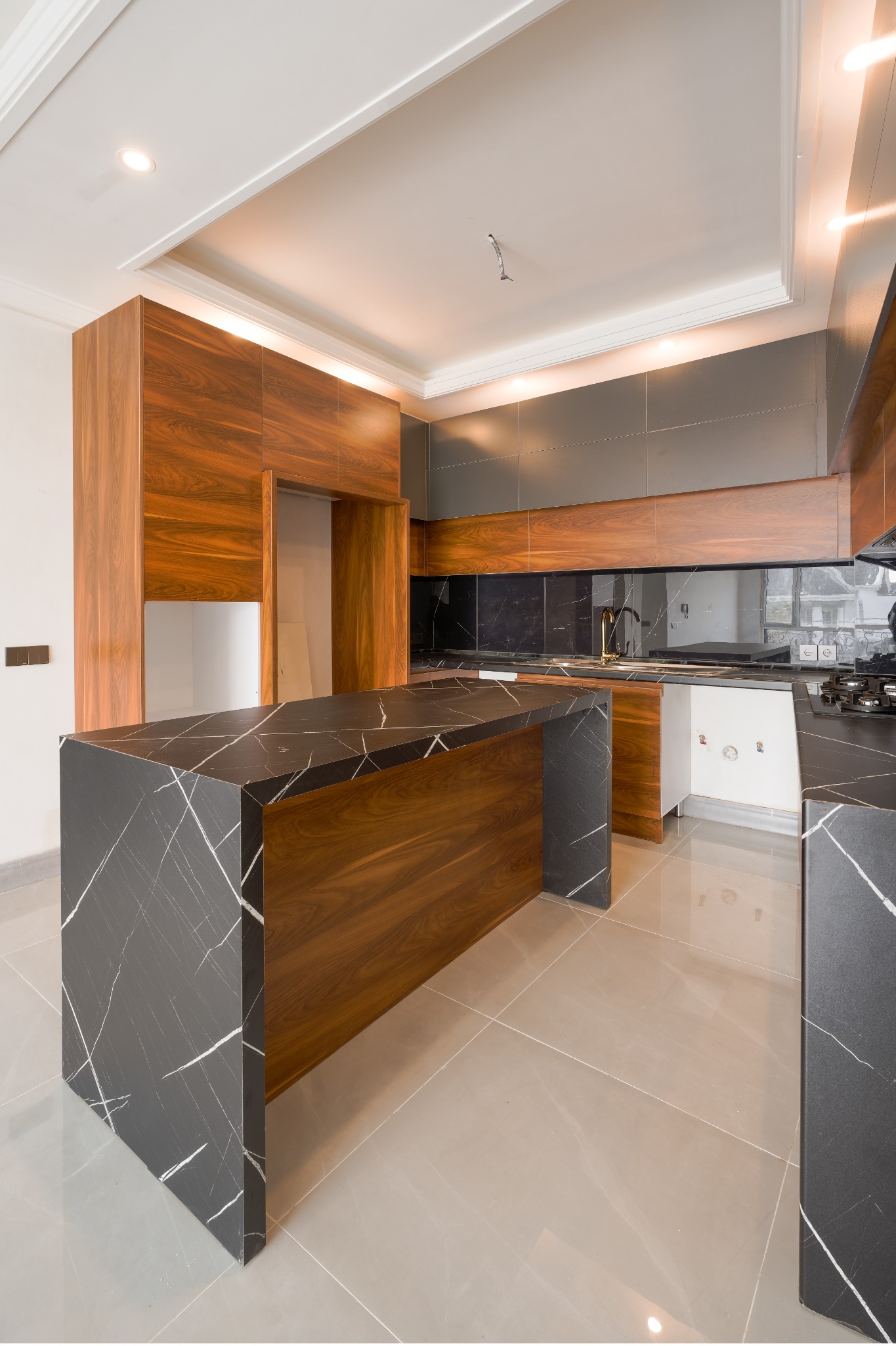 Walnut kitchen island and black stone detail