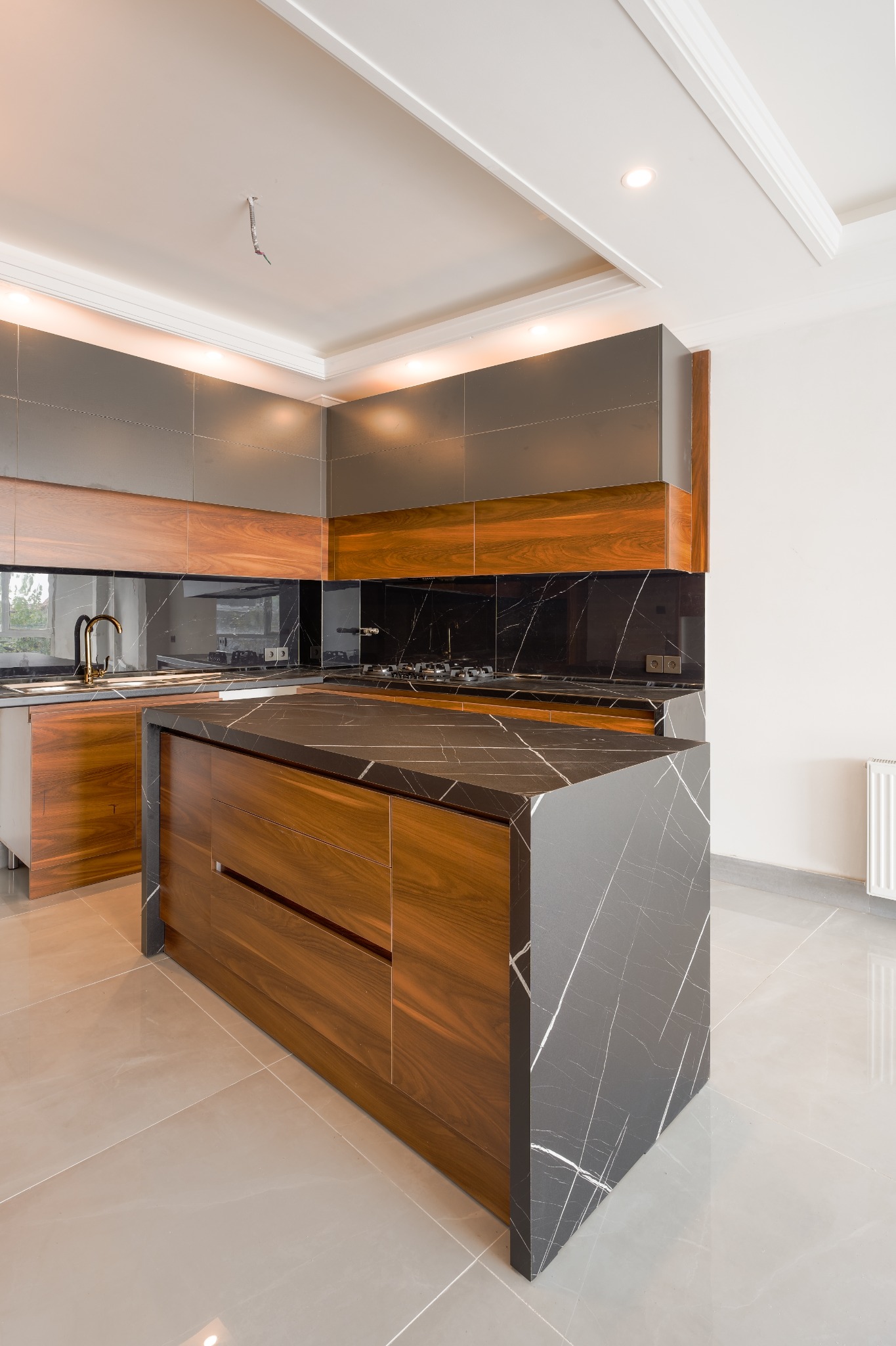 Walnut cabinetry and waterfall island