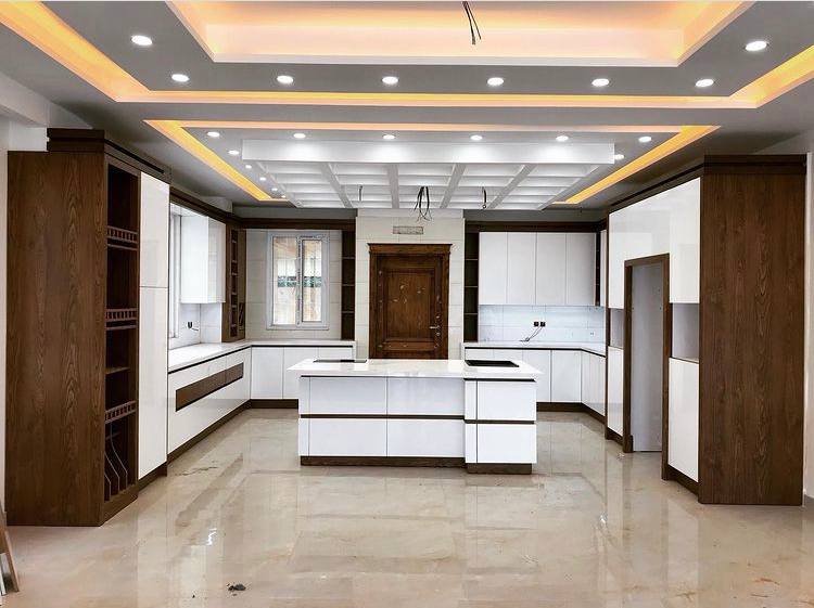 Wide view of white and walnut kitchen